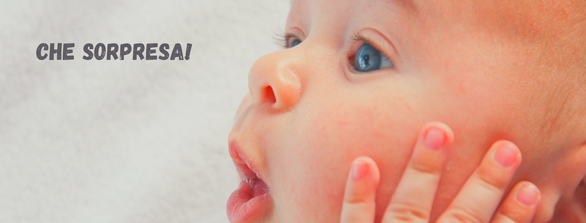Immagine di neonato che apre la bocca a O per la sospresa. Scritta: "Che sorpresa!"